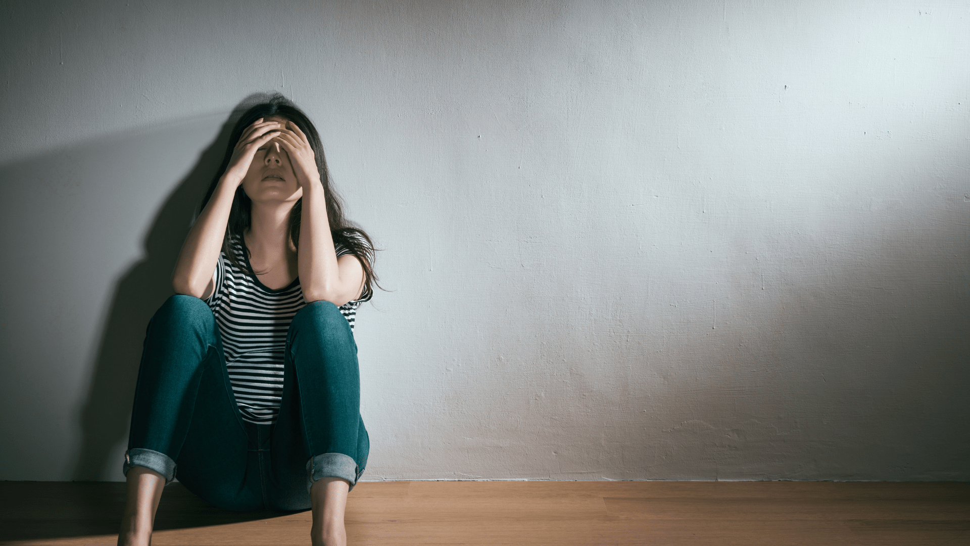 woman sitting on the floor looking desperate exhausted