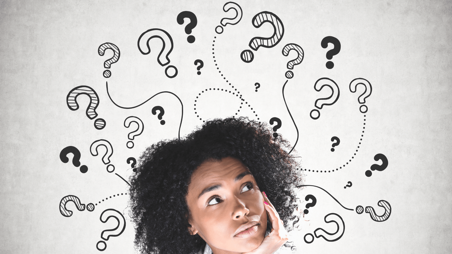 woman looking up questioning her thoughts with multiple question marks around her head
