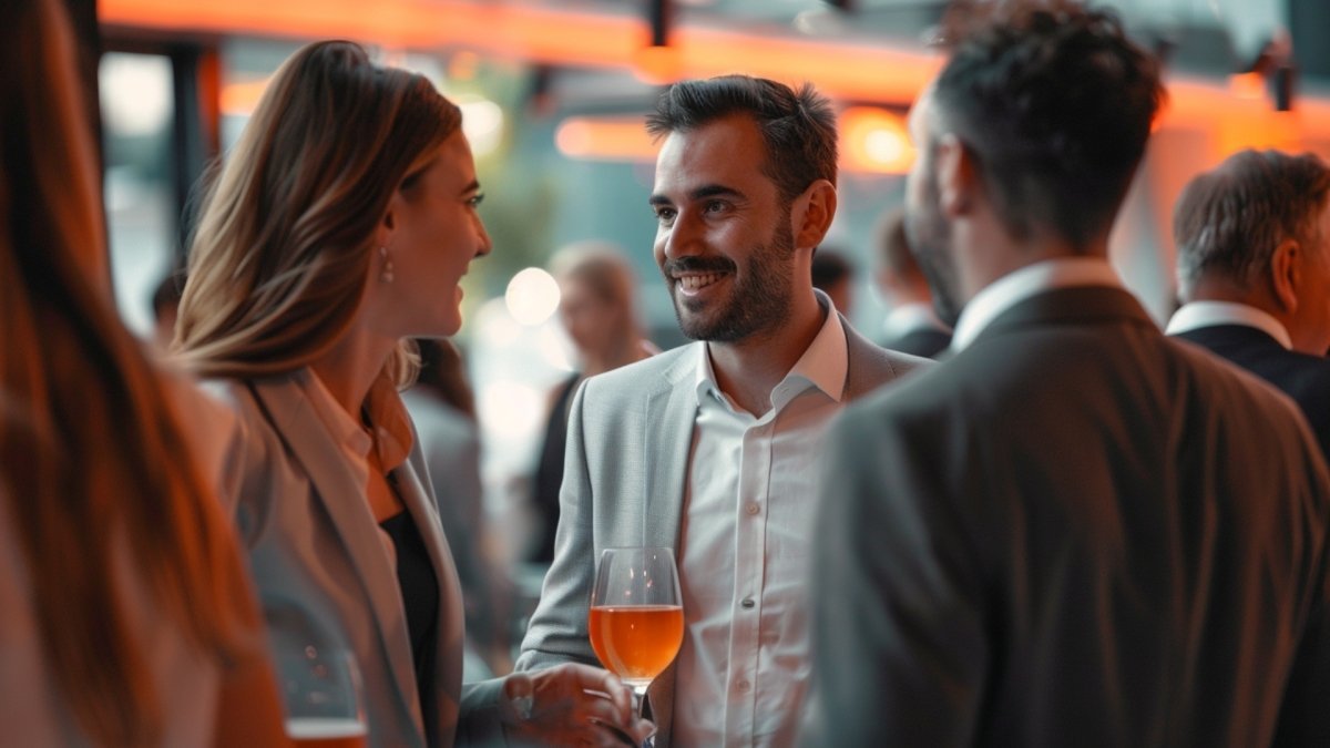A socially confident man speaking with his colleagues at product launch party