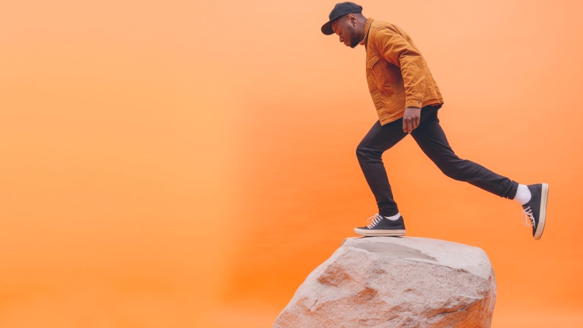 man balancing on a rock 