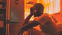 Man sitting at a corner feeling stupid for a mistake he made