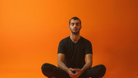 Man practicing Chakra meditation to balance energy center