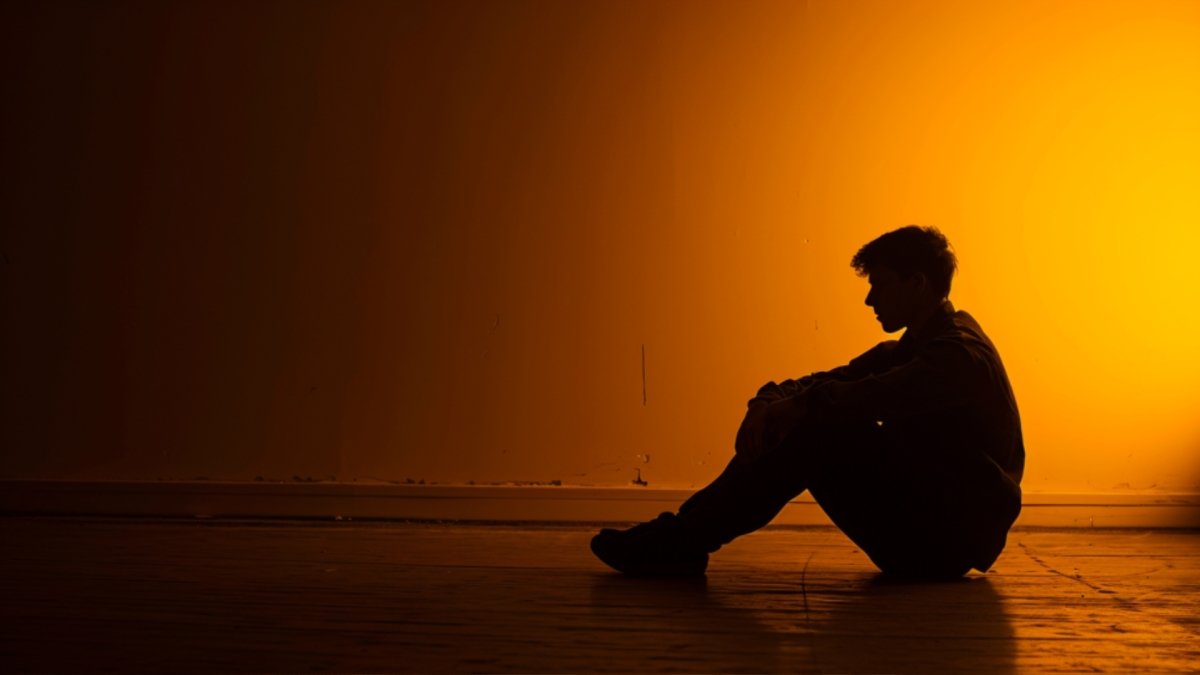 A man sitting alone in the room abandoning himself