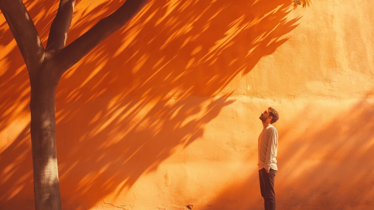 Man standing under tree in sunlight counting his blessings