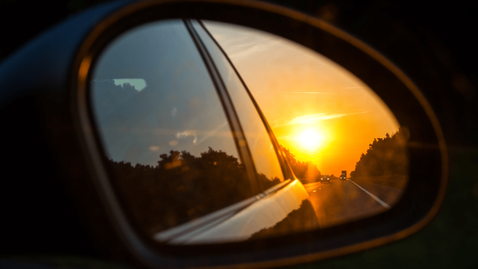 side mirror of a car at sunset