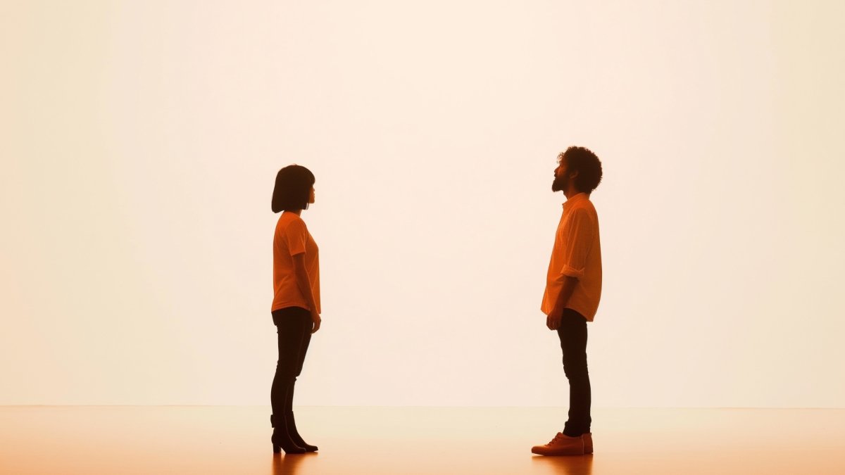 A man and a woman standing in front of each other, attracted to each other