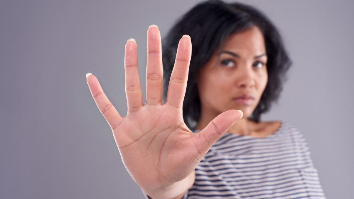 woman's hand showing to stop making excuses